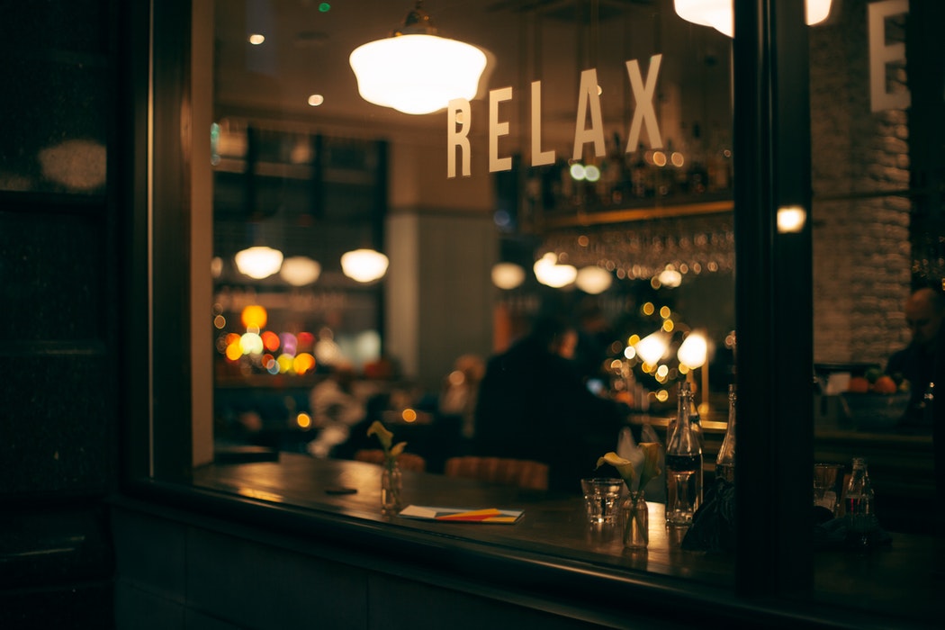 A quiet bar with 'relax' printed on the window